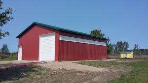 Metal pole barn with drive-thru overhead door